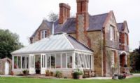 Large hipped conservatory over balcony